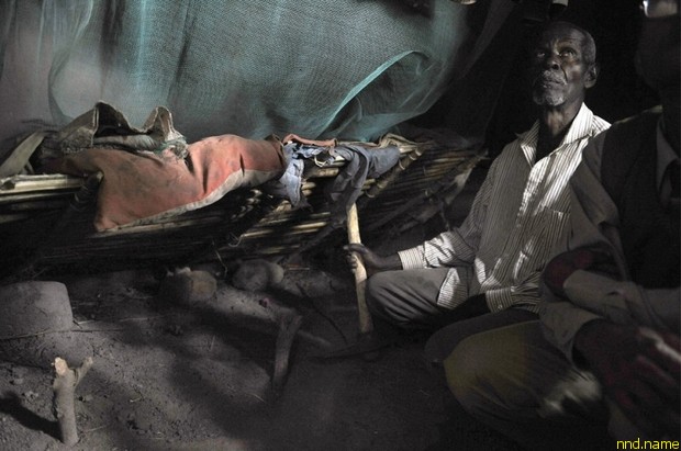 76-летний Мабула сидит на корточках в спальне с земляным полом, возле могилы своей внучки